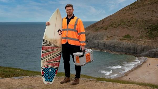 Engineer with surfboard